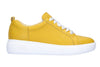 Ladies bright yellow leather trainer shoe with white ribbon laces, thick white sole.