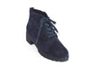 Overhead view of navy blue suede ankle boots with black chunky grippy sole and heel