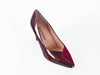 deep red mid height heeled shoe with patent leather and rich suede overlapping on the front of the shoe