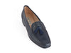 Smart navy blue leather ladies loafer with black suede tassel on the top and the feature stitching detail of a moccasin shoe. 