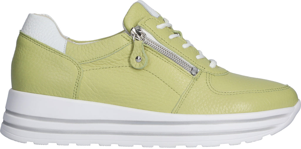 Lime green leather trainers with white ankle contrast and a thick white sole with two feature tramlines. Side zip and white laces. Side view. 