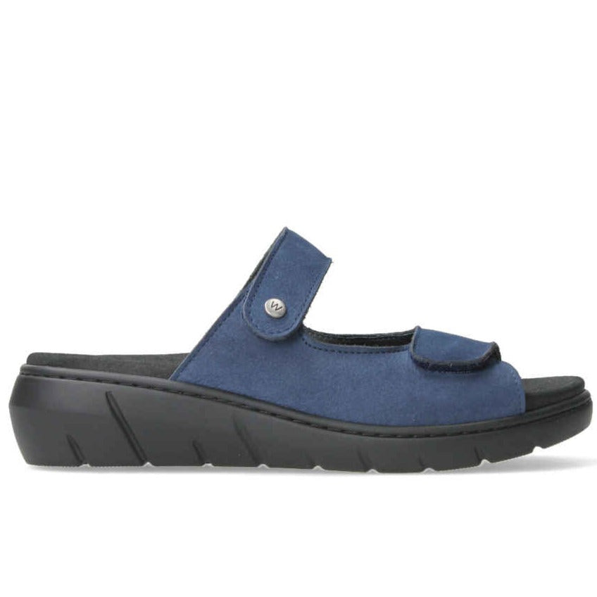 Denim blue suede leather top, with two adjustable straps, on a solid black cushioned sole. 