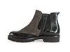 Brogue style ankle boot with patent black leather and taupe brown nubuck. Elasticated side and zip. Thick rubber sole. 
