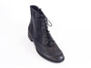 Overhead view of smart black leather ladies ankle boot with fine laces, flat heel and elegant punched leather detail