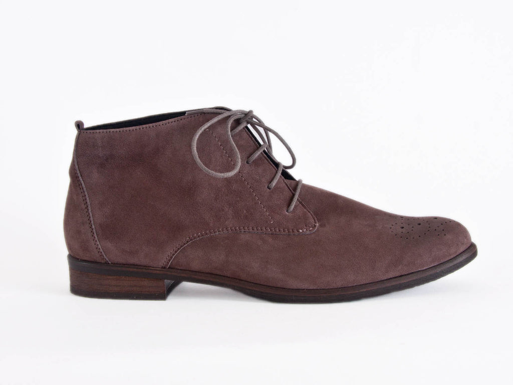 Side view of grey brown nubuck leather desert boot with wood effect flat heel and brogue style punched toe detail