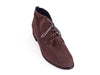 Overhead view of grey brown nubuck leather desert boot with wood effect flat heel and brogue style punched toe detail