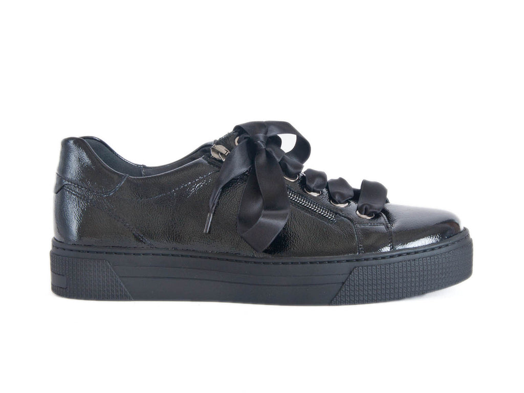 Shiny black ladies shoe with ribbon laces and a thick flat black sole