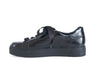 Shiny black ladies shoe with ribbon laces and a thick flat black sole