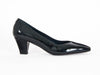 black grey mid-height heeled shoe with glossy patent leather on one side and rich suede on the other, overlapping on the front of the shoe