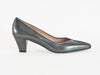 gun metal grey mid-height heeled shoe with glossy patent leather on one side and rich suede on the other, overlapping on the front of the shoe