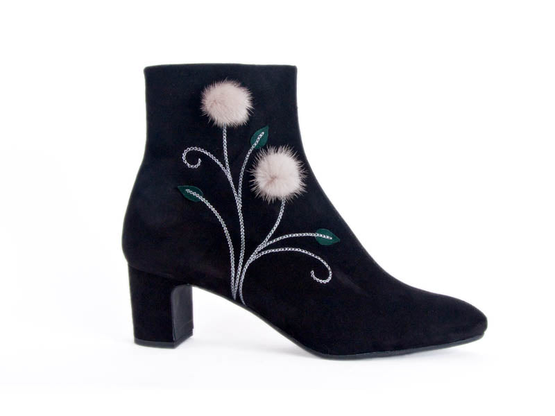 smart black boots with chain stitched stems with small green leaves and fluffy dandelion style flower heads