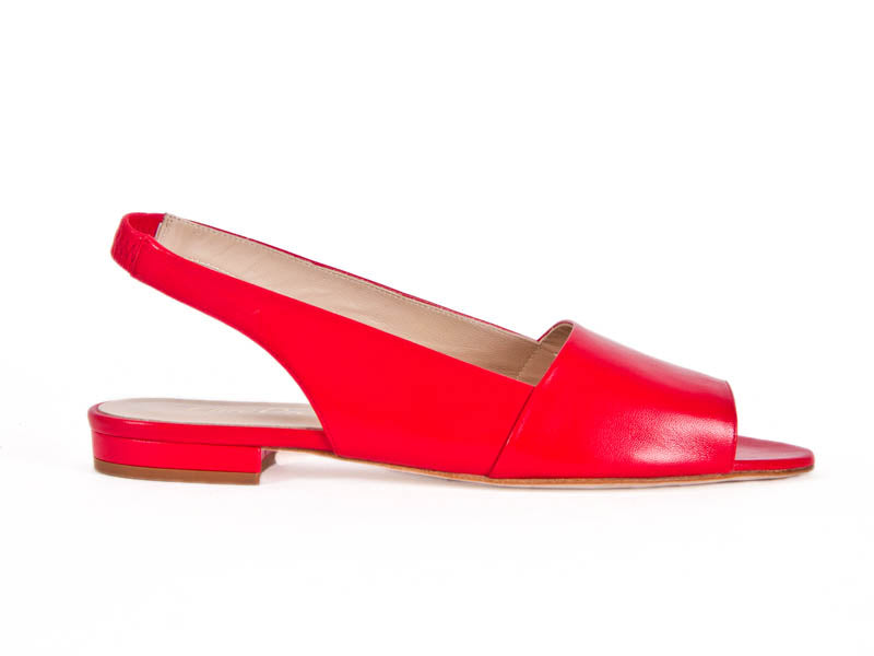 Red slingback sandal shoes, with flat heel and simple two part leather structure. side view. 